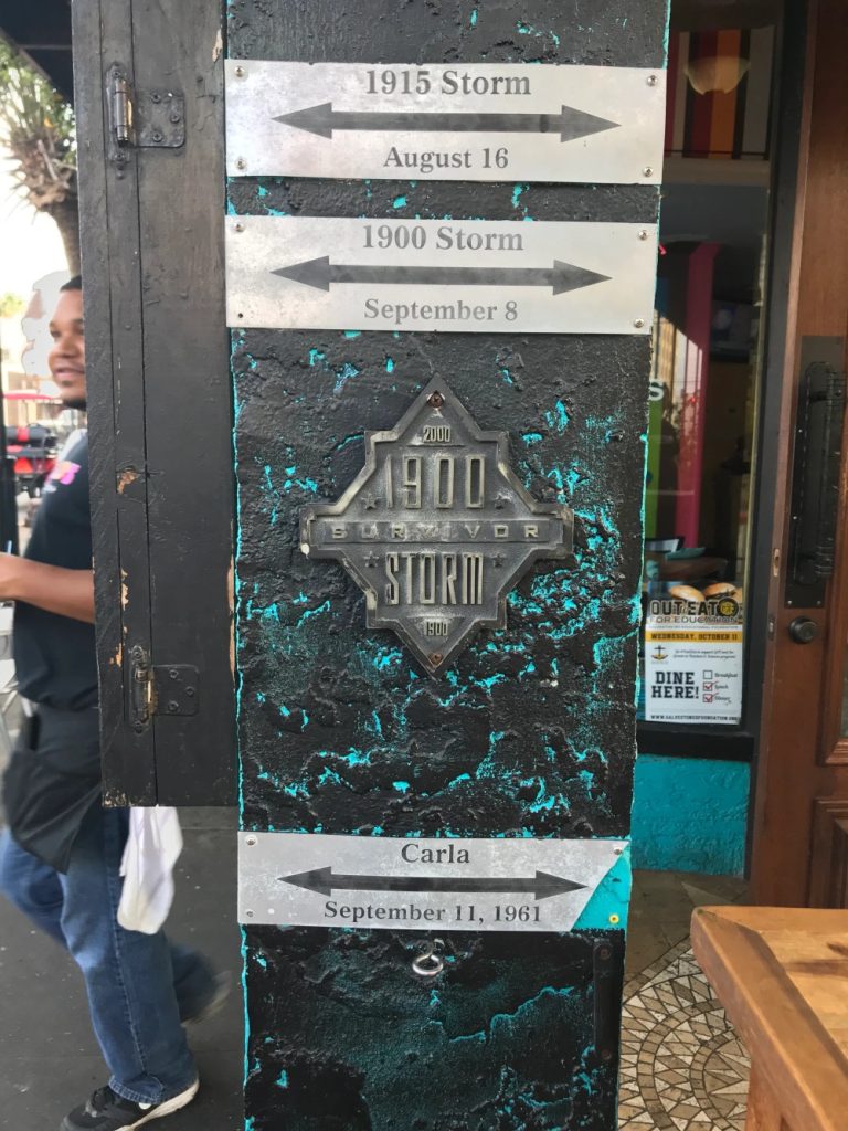 Photo of a doorway with a plaque and marks indicating flood levels of historic floods.