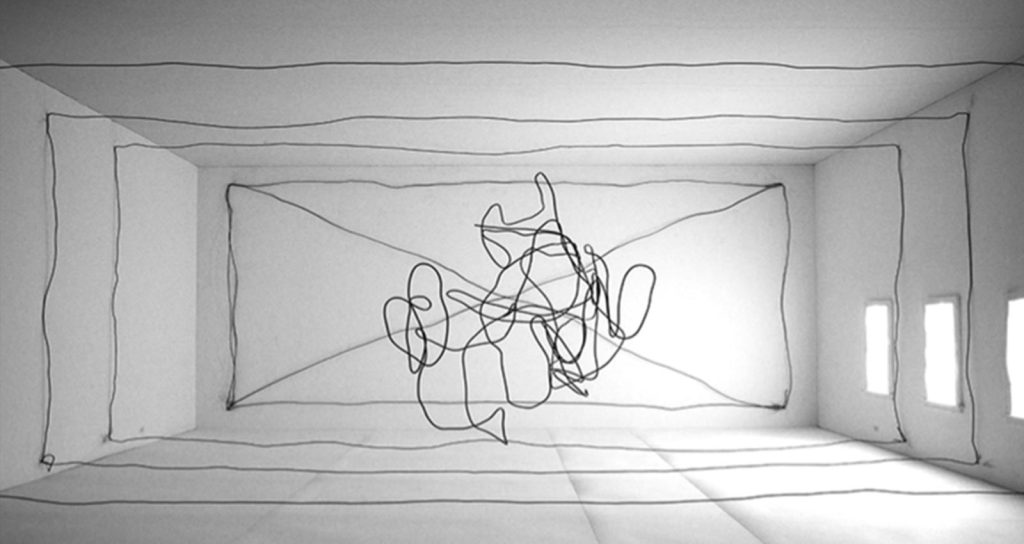 Image of an art installation featuring black string in a tangle in the middle of a room and in straight lines along the room’s walls and ceiling.