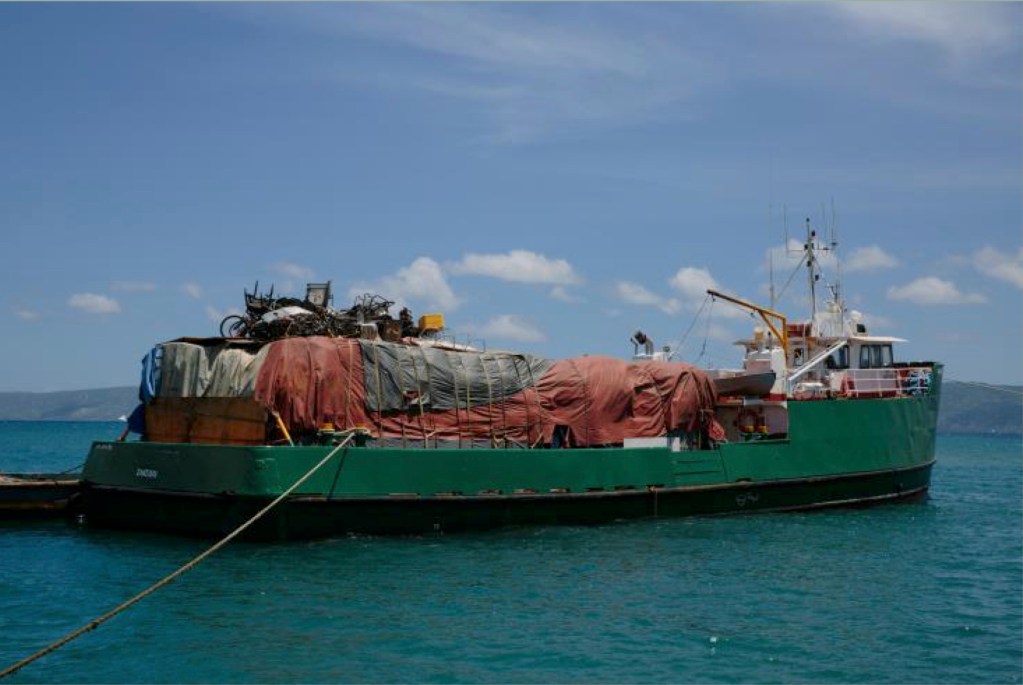 Photo of a small barge on the ocean.
