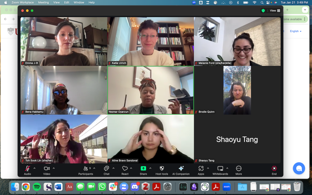 A screenshot of a zoom meeting, with nine people in a grid. Some smile, some look focused.