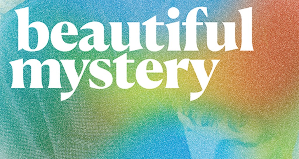The words "beautiful mystery" are in white against a pixelated, rainbow background. The outline of a child's face is faintly visible in the colors.