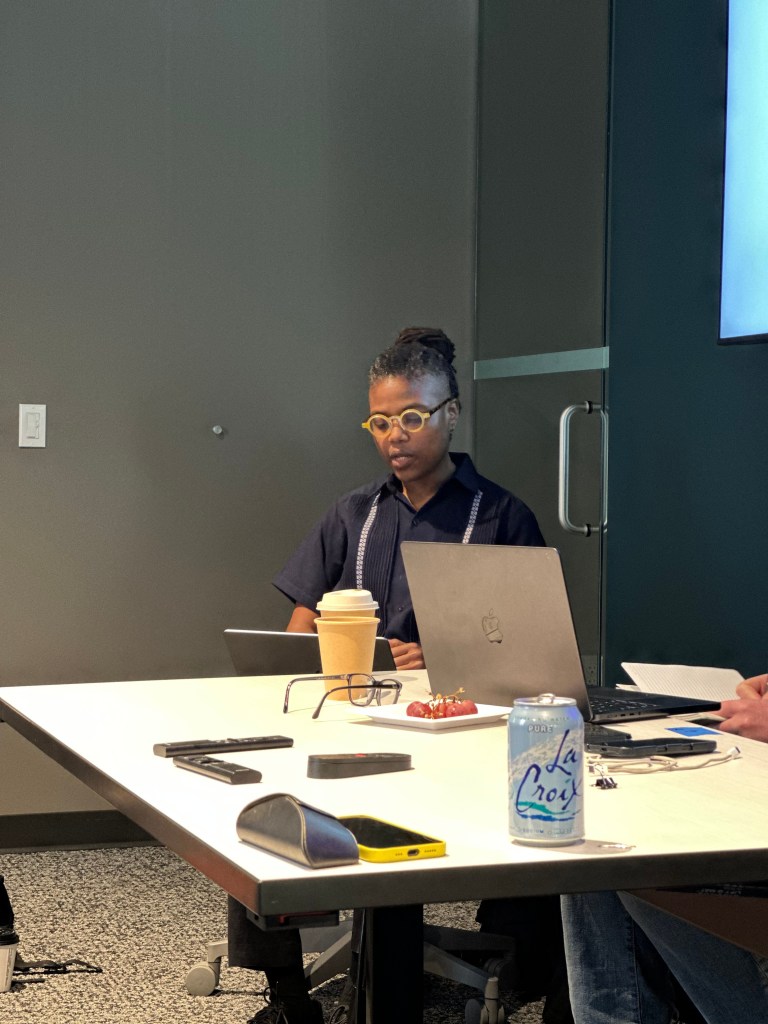 LeShandra Sullivan sits at a conference table and speaks.
