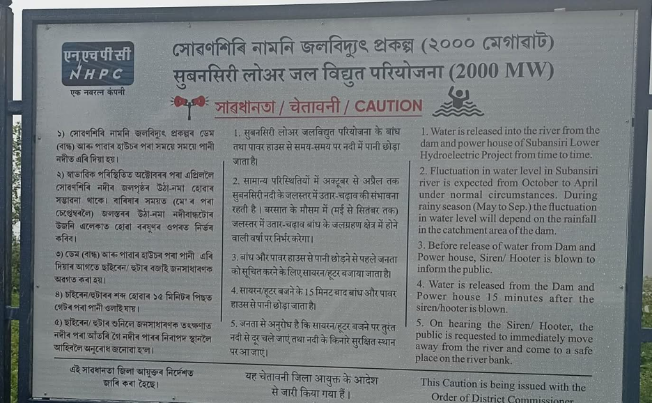 Sign in multiple languages cautioning about water release from a nearby dam.