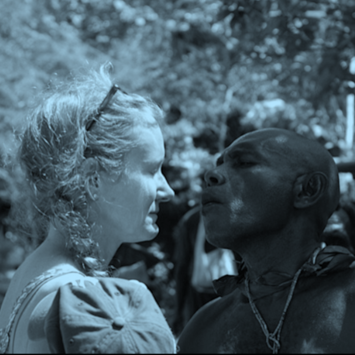 Image with a blue filter of Paige West face to face with an interlocutor