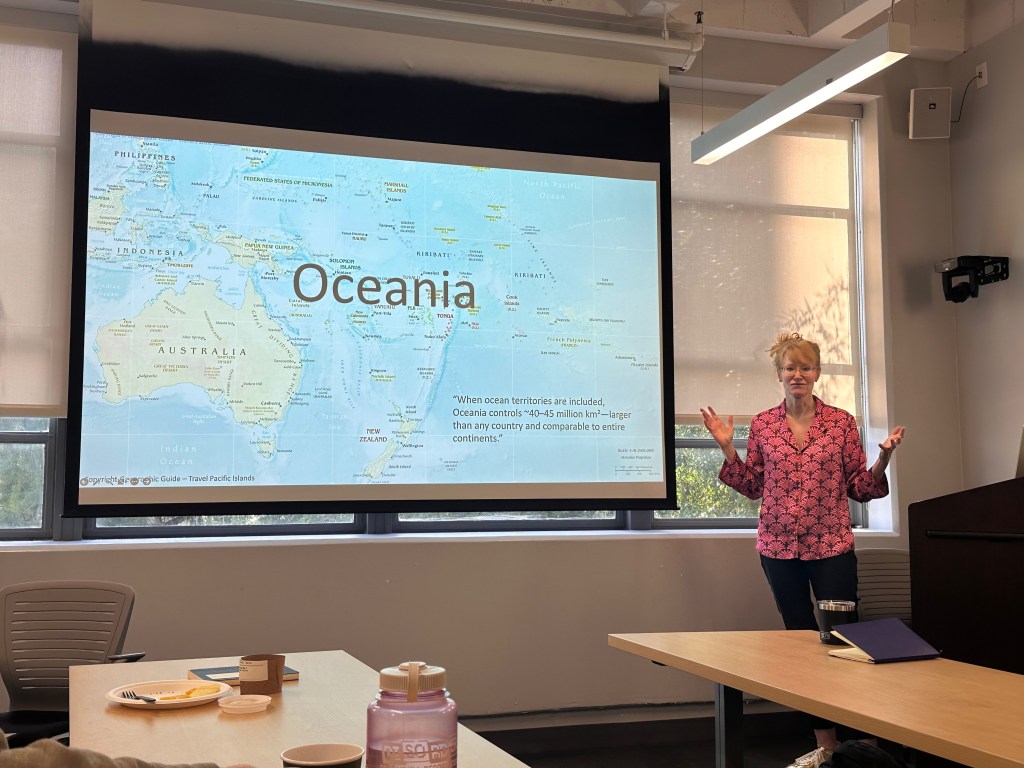 Paige West next to a map of Oceania
